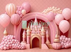 a pink castle surrounded by balloons and other decorations