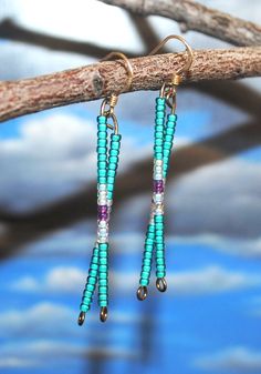 seed bead dangle earrings. white and purple drop from top of ear wire to bottom is 2 1/8". Earrings are made by Native American. Purple Dangle Earrings With Tiny Beads, Adjustable Purple Earrings With Tiny Beads, Adjustable Wire Wrapped Purple Beaded Earrings, Adjustable Purple Wire Wrapped Beaded Earrings, Purple Adjustable Earrings With Tiny Beads, Purple Beaded Dangle Earrings With Tiny Beads, Adjustable Long Drop Beaded Earrings, Nickel Free, Nickel Free Long Drop Beaded Earrings, Nickel Free Adjustable Long Drop Beaded Earrings