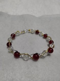 This lovely, yet simple, braided bracelet is made of clear quartz and red glass braided with gold and silver dipped wire. Braided Wire Bracelet, Friend Crafts, Braided Bracelet, Fashion Design Sketches, Wire Bracelet, Braided Bracelets, Red Glass, Friday Night, Clear Quartz