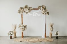 a wedding arch decorated with flowers and greenery