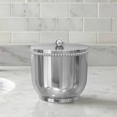 a silver container sitting on top of a marble counter