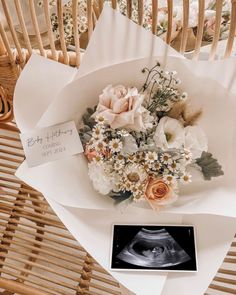 a bouquet of flowers sitting on top of a wooden chair next to an x - ray