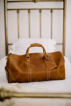 "Handmade Leather Weekend Duffel Bag Travel Bag Suitcase | Genevieve Marcel The Weekend duffel will always be dependable for any short trip. Allowing for items to be placed comfortably, compact, and safe. This high-quality design is there to exaggerate functionality and productivity, with a compartment designed specifically for shoes. Other interior pockets are included which will allow for storage of laptops as well as other accessories. It's completed with a comfortable leather handle will all Everyday Cognac Rectangular Travel Bag, Cognac Rectangular Travel Bag For Everyday Use, Cognac Travel Bag With Leather Backing, Rectangular Cognac Travel Bag For Everyday Use, Classic Brown Travel Accessories For On-the-go, Daily Use Leather-lined Rectangular Duffle Bag, Classic Travel Bag With Leather Backing For Daily Use, Rectangular Leather Weekender Bag For Travel, Leather-backed Travel Briefcase Tote