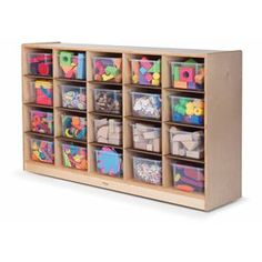 a wooden toy storage unit with trays filled with plastic letters and alphabet's