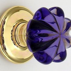 an image of a purple flower knob on a white wall or doorknobl