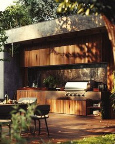 an outdoor kitchen and dining area is shown in this image, with wood paneling on the outside wall