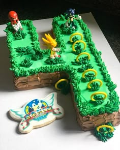 a cake shaped like a letter with sonic and tails on it