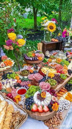 a table filled with lots of different types of food and desserts on top of it