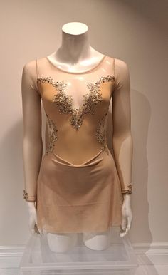 a mannequin wearing a dress with gold sequins on it's back