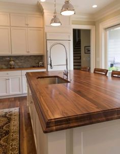 a large kitchen island with wooden counter tops