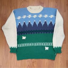 an ugly sweater with sheeps on it sitting on the floor