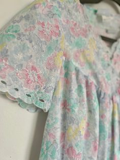 Step into a dreamy world with this enchanting Vintage Floral Watercolor Pajama Set, a perfect addition to your sleepwear collection. This unique set features a delicately embroidered nightgown with eyelet cutout details at the top, showcasing a romantic blend of pink, blue, light green, and turquoise hues. The floral, watercolor-like pattern adds a touch of whimsy, creating a truly picturesque design. The matching robe is a standout piece with its half-zipper closure and asymmetrical tie, adding Multicolor Floral Print Sleepover Sets, Multicolor Floral Print Set For Sleepover, Multicolor V-neck Sleepwear For Loungewear, Multicolor Floral Print Short Sleeve Sleepwear, Multicolor Floral Print Sleepwear With Short Sleeves, Multicolor Short Sleeve Sleepwear With Floral Print, Multicolor Short Sleeve Sleepwear For Spring, Spring Multicolor Nightgown For Sleepovers, Multicolor Spring Nightgown For Sleepovers