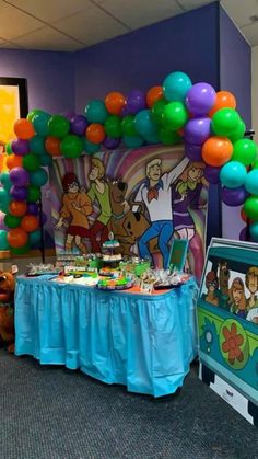 a party with balloons and decorations in the shape of cartoon characters