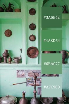 A display of antique copper and brassware arranged on shelves against a vibrant mint green wall. The image showcases a captivating mint green color palette reminiscent of a digital color scheme generator.