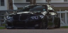 a black car parked in front of a house