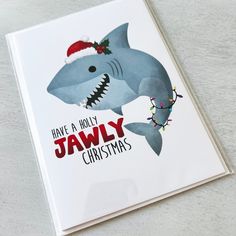 a christmas card with a shark wearing a santa hat and the words have a holly jawsy christmas written on it