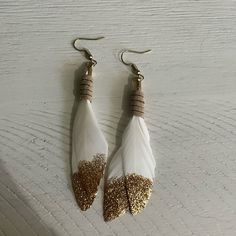 two pairs of white and gold feather earrings