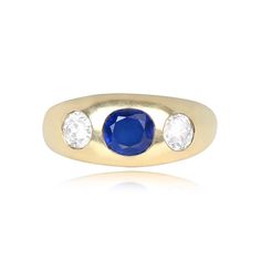 This three-stone gypsy ring features a no-heat Burma sapphire flanked by two old European cut diamonds. The sapphire weighs approximately 1.20 carats and is oval cut. The diamonds weigh approximately 0.70 carats combined and are H color, VS2-SI1 clarity overall. This vintage ring was handcrafted in 14k yellow gold circa 1950.
The width of the band ranges from 4.11mm – 9.60mm.
This ring is currently size 10 and can be resized to any finger size at no extra cost.
Ready to Make It Yours? Contact us Timeless Round Three Stone Sapphire Ring, Heirloom Three Stone Sapphire Ring, Heirloom Sapphire Ring With Three Stones, Heirloom Sapphire Three Stone Ring, Yellow Gold Three Stone Sapphire Ring, Yellow Gold Three-stone Sapphire Ring, Classic Sapphire Three Stone Diamond Ring, Classic Sapphire Three-stone Diamond Ring, Vintage Three Stone Round Sapphire Ring