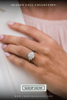 a woman's hand with a diamond ring on it