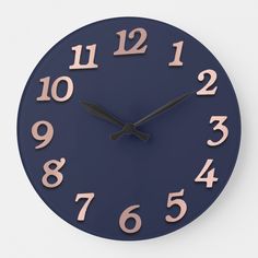 a blue clock with pink numbers on it