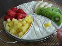 there is a platter with fruit on it and one has strawberries, kiwis, and bananas