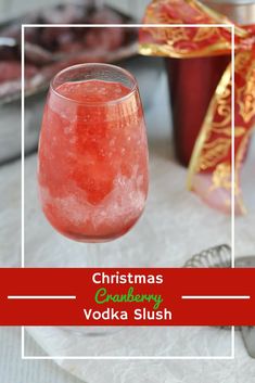 a christmas cranberry vodka slush in a wine glass with the words christmas cranberry vodka slush