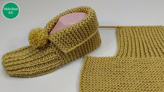 a pair of knitted slippers next to a crochet pot holder on a white surface