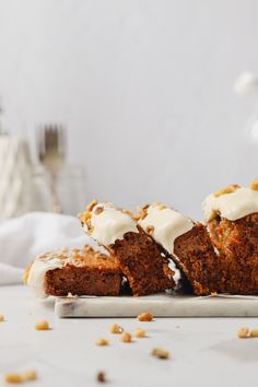 carrot muffins with icing on a white plate