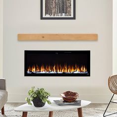 a living room with a couch, coffee table and fire place in front of the fireplace