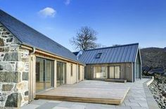 a stone building with a wooden deck next to it