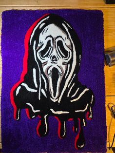 a rug with a painting of a person wearing a hoodie and dripping blood on it