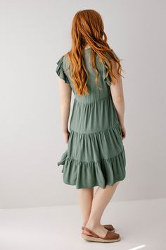 Introducing the 'Paloma' midi dress! This midi dress is in a stunning jade color and features a beautiful tiered silhouette. Carrying both comfort and feminine grace, this dress is a great addition to your warm weather closet! Pair with brown sandals and a tote bag for a casual day out or a brunch with friends. 70% Rayon 30% Linen Wash Inside Out Wash Cold Gentle Cycle Do Not Bleach Hang to Dry Low Iron if Needed Do Not Dry Clean Partially Lined Great petite length option! Model Height 5'6" | We Flowy Knee-length Midi Dress With Ruffles, Flowy Ruffle Midi Dress For Brunch, Flowy Midi-length Ruffle Dress For Brunch, Solid Midi Dress With Ruffle Hem, Solid Midi Dress With Ruffles, Summer Short Sleeve Sage Dress, Short Sleeve Sage Summer Dresses, Sage Short Sleeve Summer Dress, Green Midi Dress For Brunch