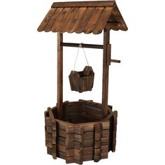 a wooden water well with a bucket hanging from it's side