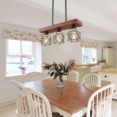 a dining room table with four chairs around it