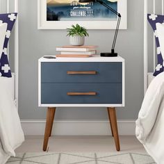 a bedroom with two nightstands and a poster on the wall next to each other