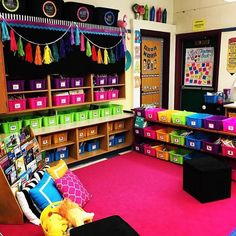 a classroom with lots of colorful bins on the floor and shelves filled with books