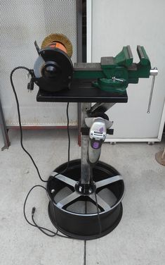 a machine that is sitting on top of a black stand with wires attached to it