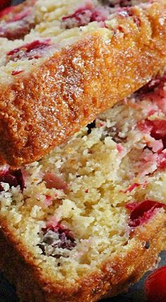 two pieces of bread with cranberries and powdered sugar on top are sitting next to each other