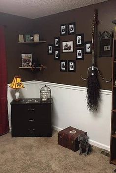 a living room with brown walls and pictures on the wall, including a bookcase