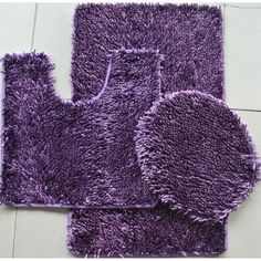 three purple rugs on the floor with white tiles