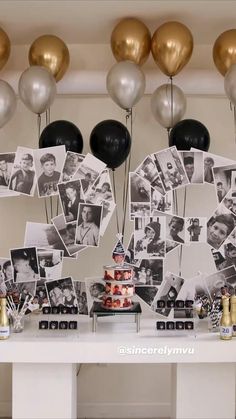 a table topped with lots of balloons and pictures