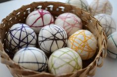 a basket filled with different colored balls on top of a table