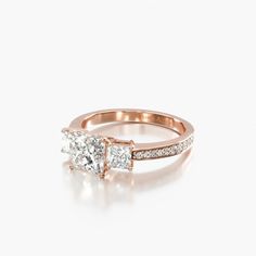 a rose gold engagement ring with two princess cut diamonds