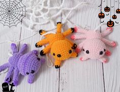 three crocheted stuffed animals sitting next to each other on a white wooden surface