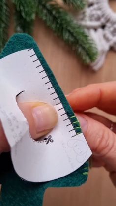 someone is holding a piece of paper with a ruler on it and pointing to the side