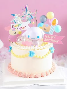 a birthday cake decorated with balloons and an animal figurine sitting on top of it