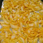 some noodles are being cooked in a pan on the stove top and ready to be eaten