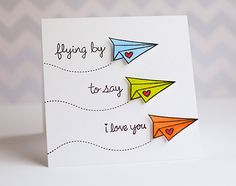 a card with three paper airplanes on it and the words flying by to say i love you