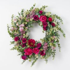 a floral wreath with pink and red flowers