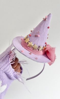 a doll wearing a purple hat with stars on it